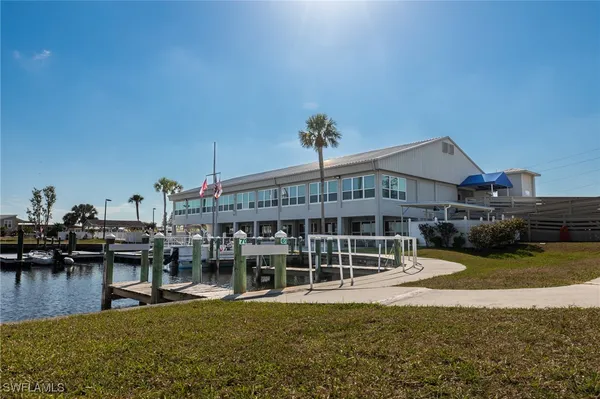 a view of a house with swimming pool and sitting area