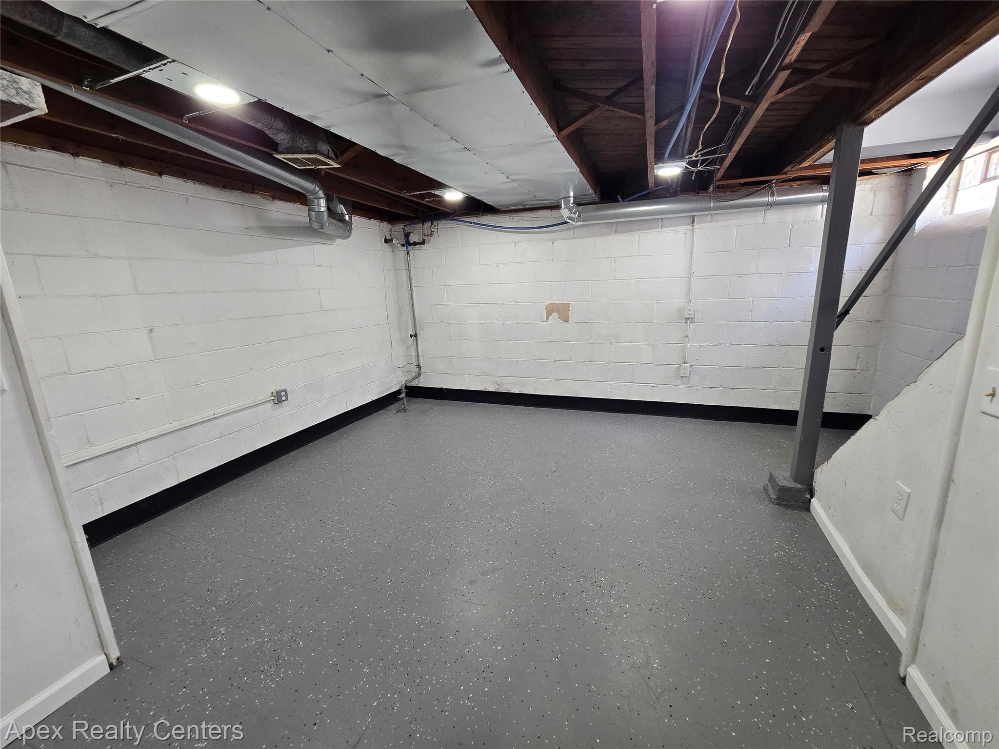 7671-7675 Evergreen Road Detroit, MI 48228 - Photo 49 of 84 7671 Evergreen. Lower level space featuring painted block walls and a gray speckled epoxy floor