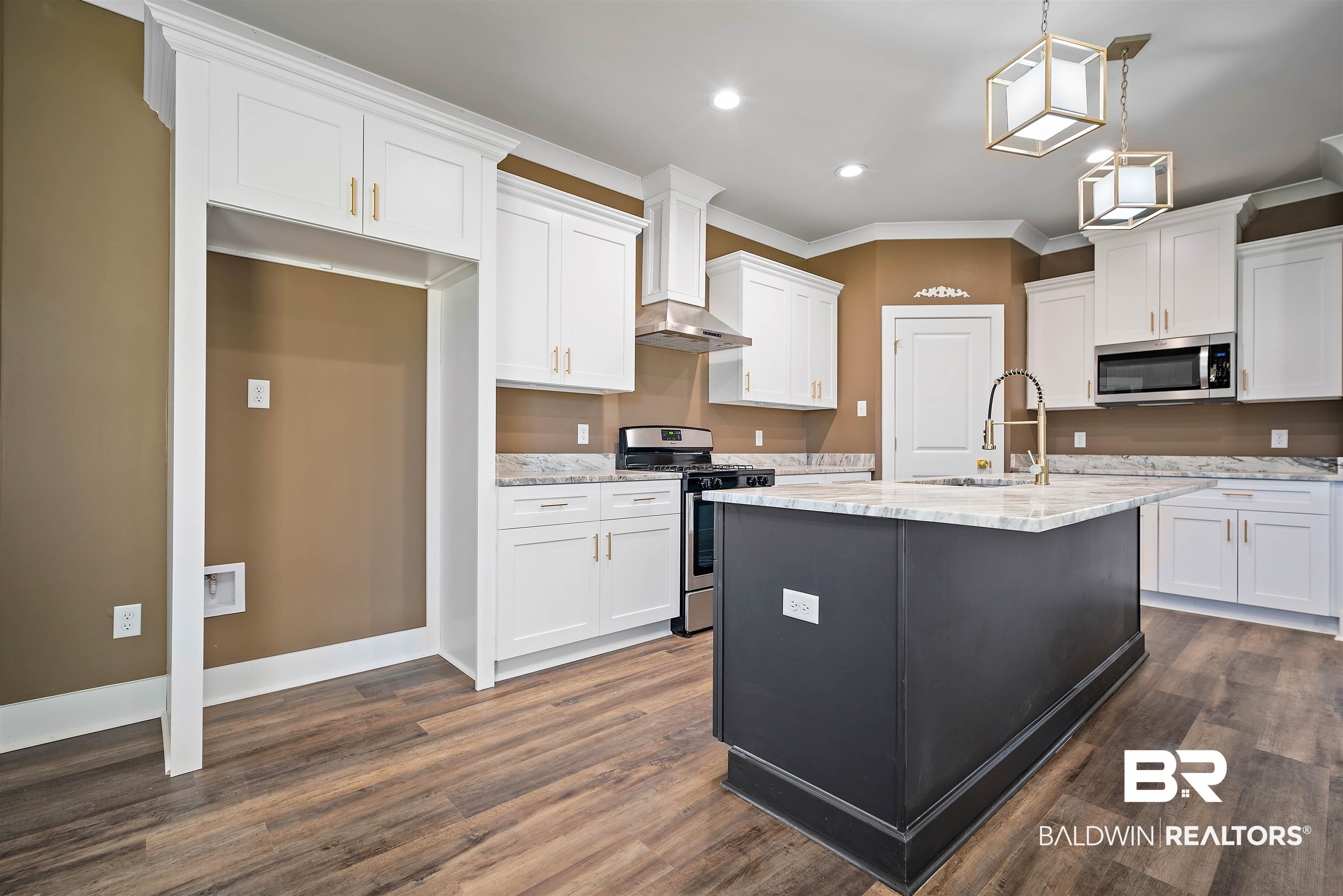 188 Hampton Ridge Mobile, AL 36608 - Photo 7 of 37 Kitchen with white cabinets, appliances with stainless steel finishes, wall chimney range hood, and designer granite counters. Eat -in Bar. Renaii tankless hot water system.