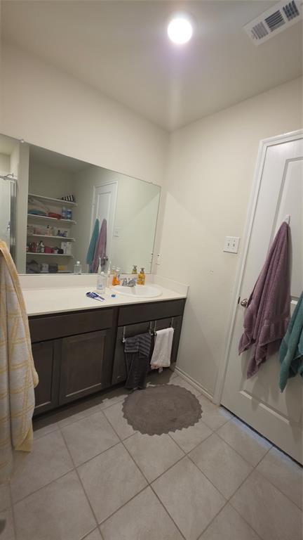 409 Samuel Street Denton, TX 76207 - Photo 32 of 40 a bathroom with a sink a toilet and mirror