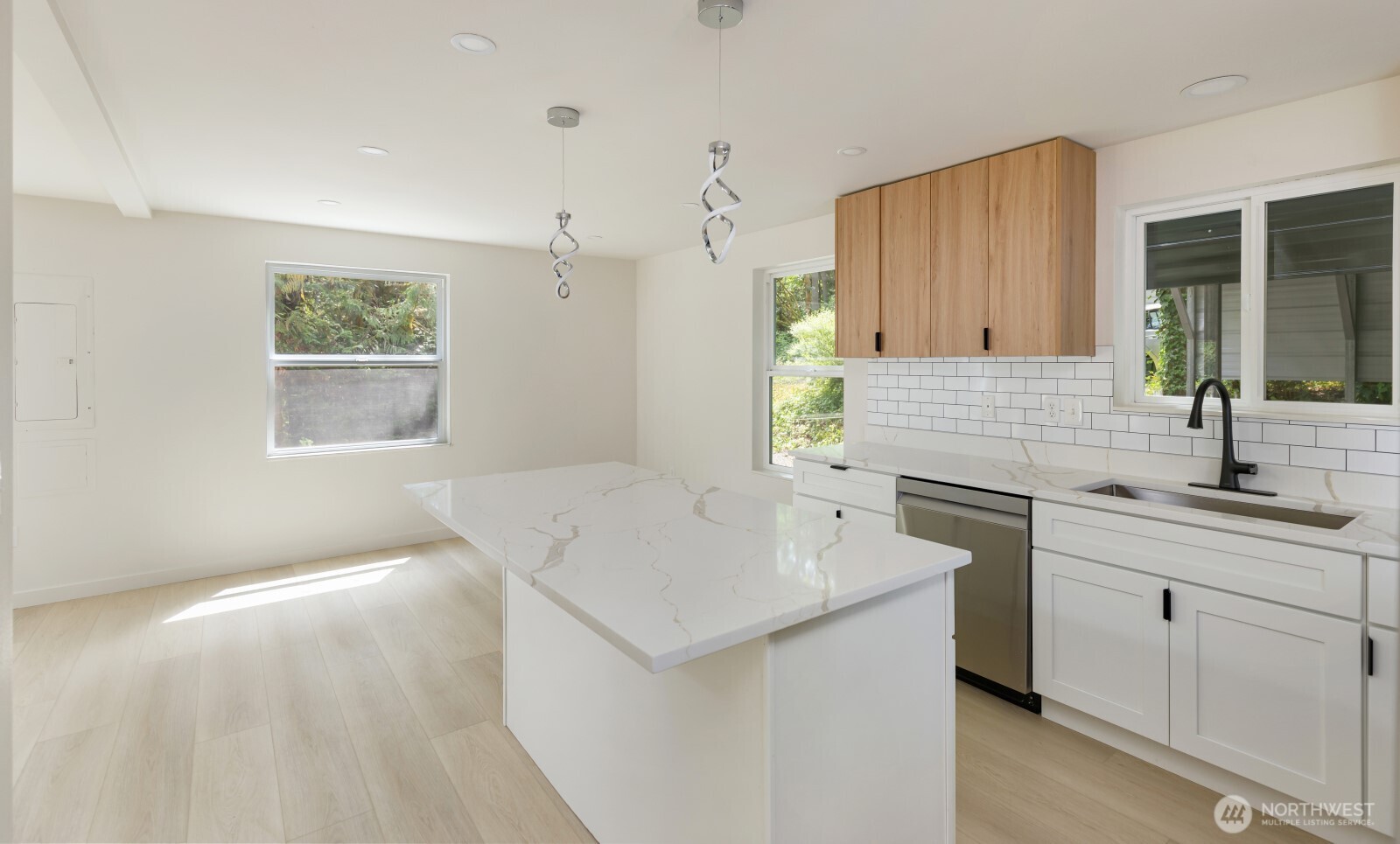7605 Northeast Hidden Cove Road Bainbridge Island, WA 98110 - Photo 31 of 36 a kitchen with a sink and cabinets