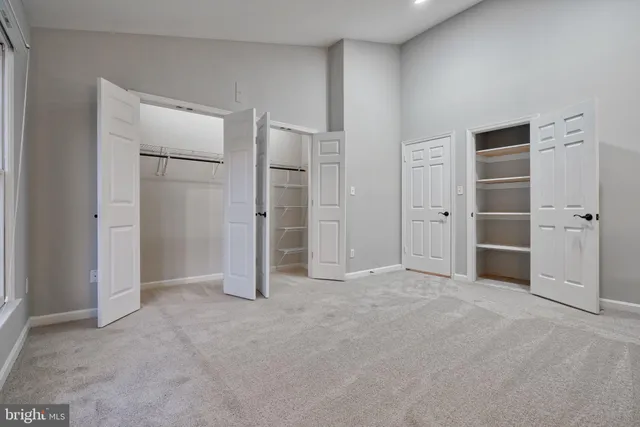an empty room with closet and wooden door