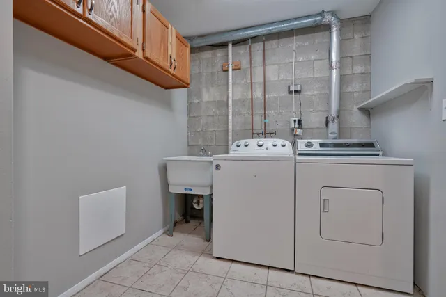 a utility room with cabinets and washer