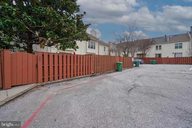 a view of a street with a car parked in front of it