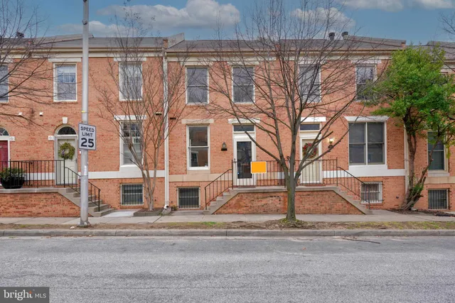 a view of a brick building next to a road