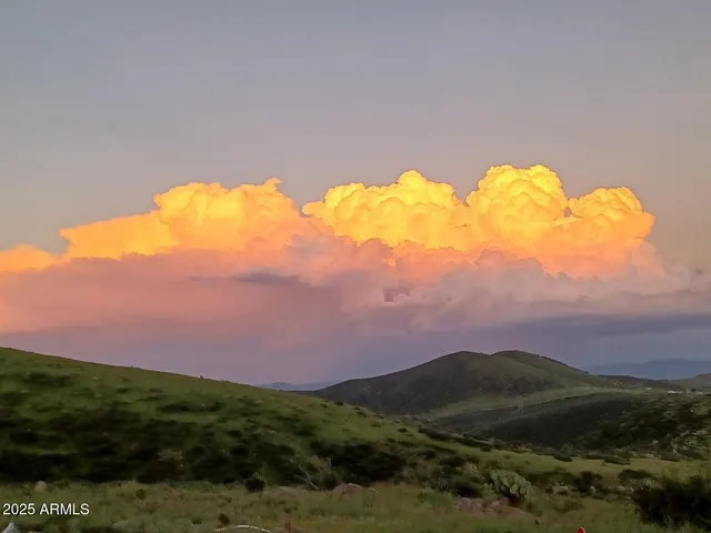a view of a lake in the sunset