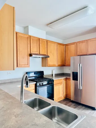 a view of a room with wooden floor and a sink