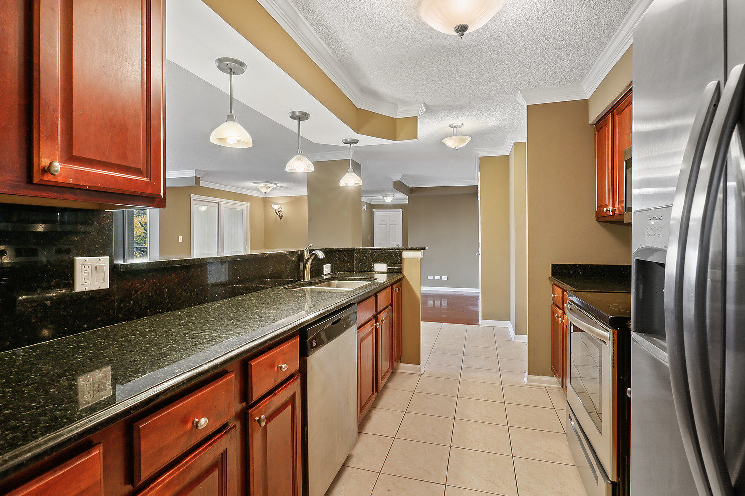 470 Fawell Boulevard, Unit 320 Glen Ellyn, IL 60137 - Photo 5 of 15 a large kitchen with stainless steel appliances granite countertop a sink and a refrigerator