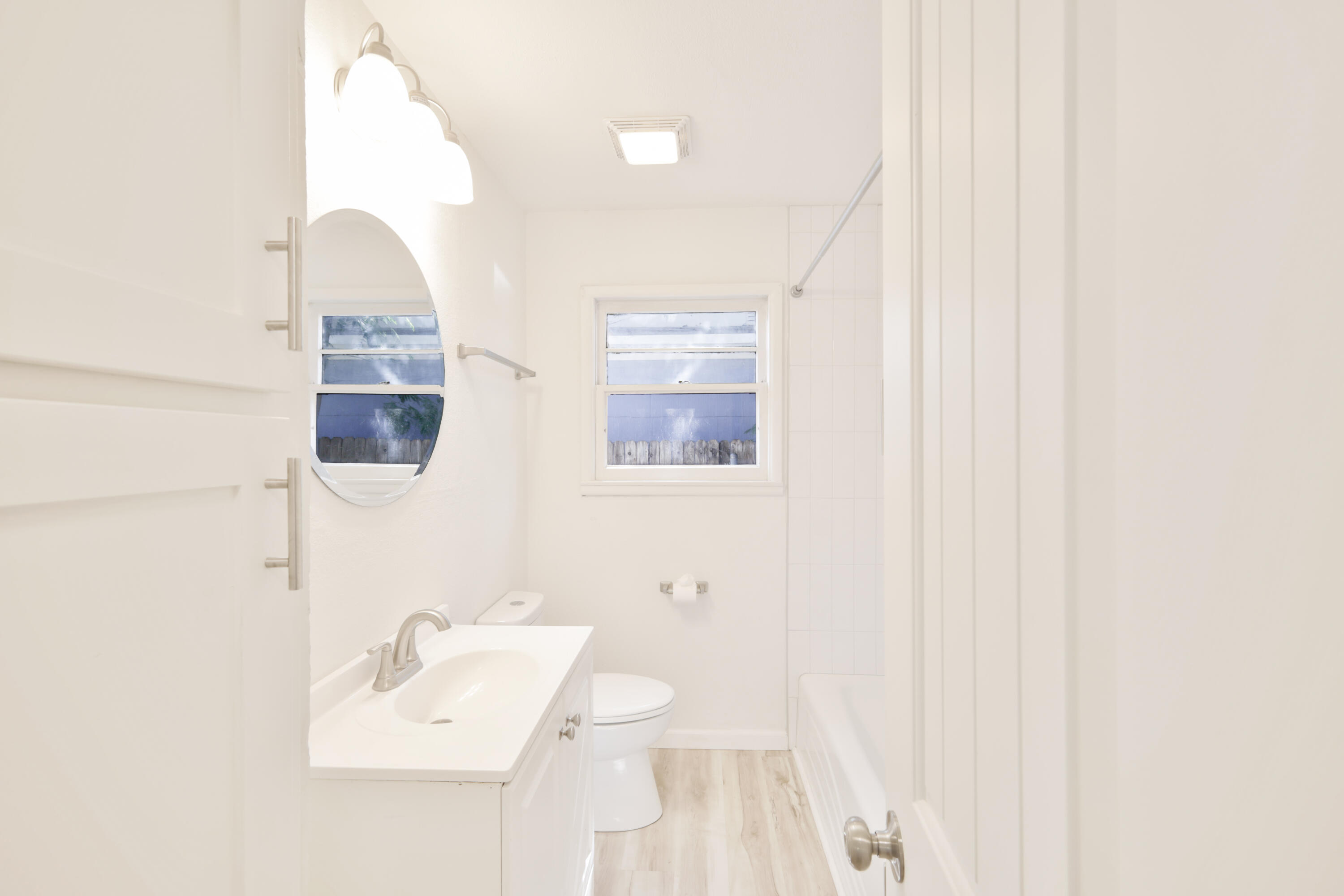 3812 31st Street Lubbock, TX 79410 - Photo 7 of 16 a bathroom with a sink and mirror
