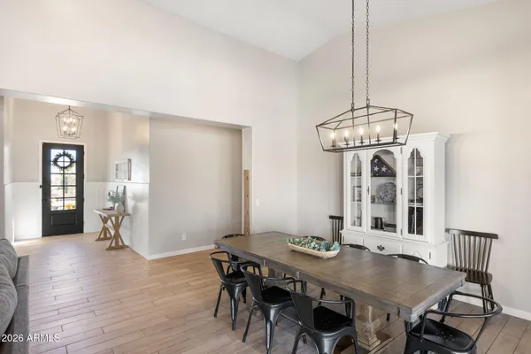 a view of a dining room with furniture wooden floor and chandelier
