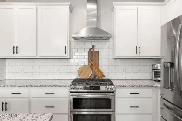 a stove top oven sitting inside of a kitchen
