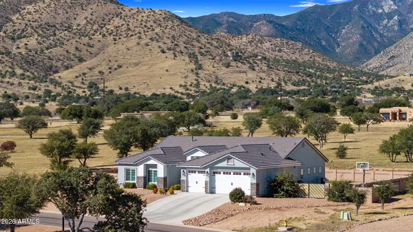 a front view of a house with a mountain