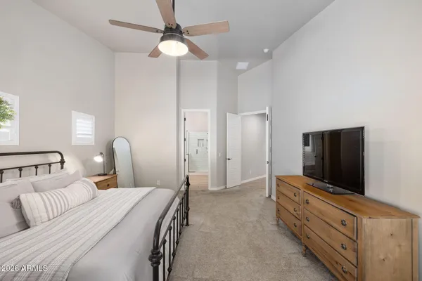 a bedroom with furniture and a flat screen tv