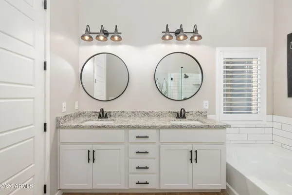 a bathroom with 2 sink and a mirror