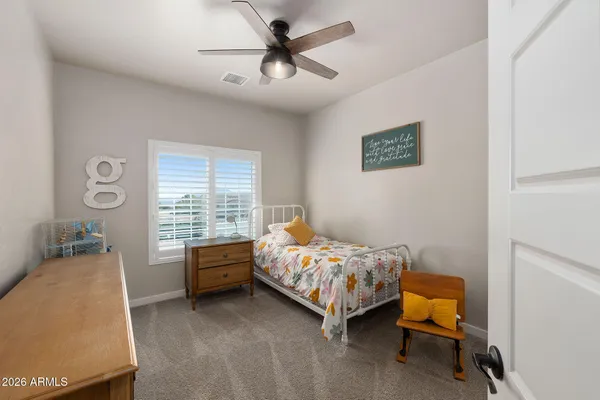 a bedroom with bed and a window