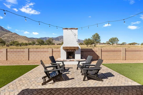 a view of a patio with table and chairs potted plants and a palm tree