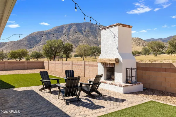 a view of a patio with table and chairs with wooden floor and fence