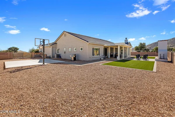 a view of a house with a patio and a yard