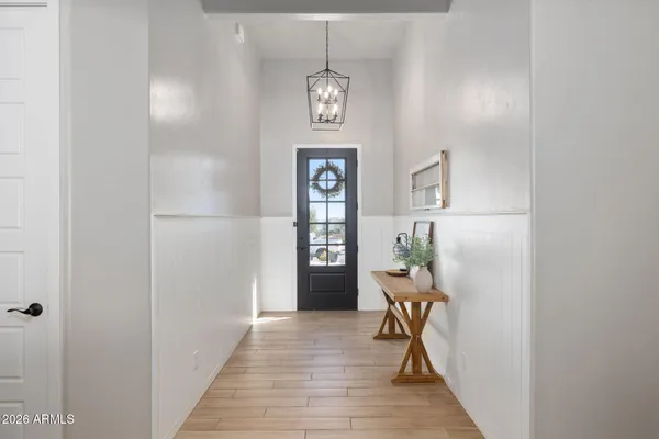 a view of a hallway with wooden floor windows and entryway