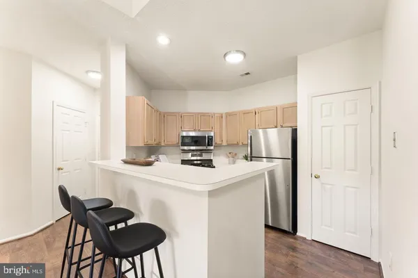 a kitchen with a sink a refrigerator a stove top oven a washer and dryer