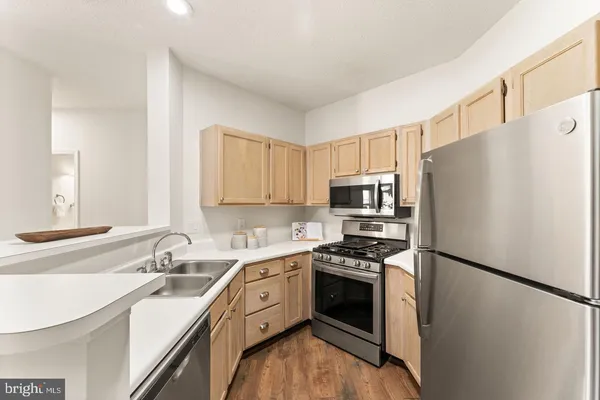 a kitchen with a sink a counter top space and appliances