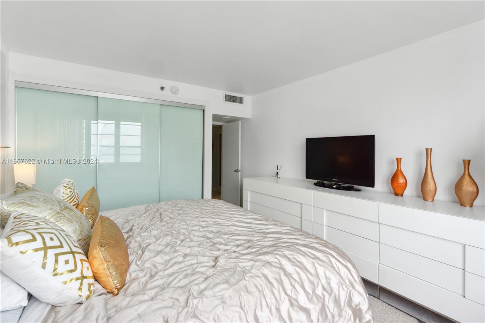 100 Lincoln Road, Unit 1534 Miami Beach, FL 33139 - Photo 12 of 25 a bedroom with a bed and a flat screen tv