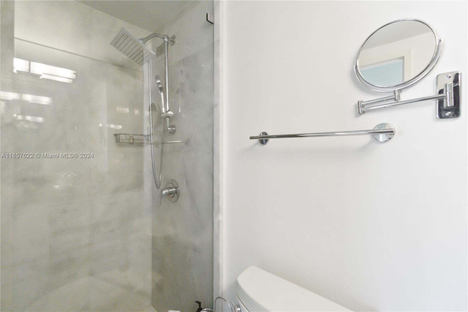 100 Lincoln Road, Unit 1534 Miami Beach, FL 33139 - Photo 14 of 25 a bathroom with a granite countertop shower a toilet and a sink