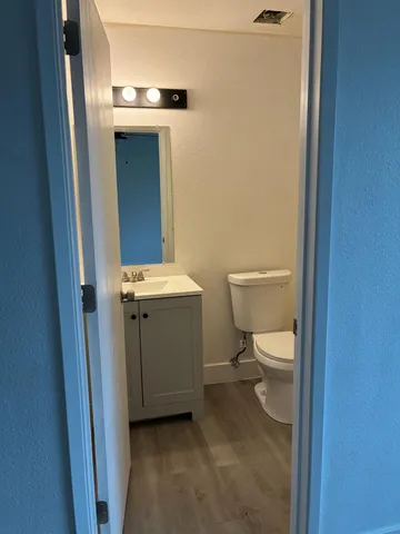 a bathroom with a toilet sink and mirror