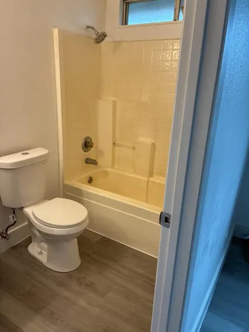 a bathroom with a toilet and a shower