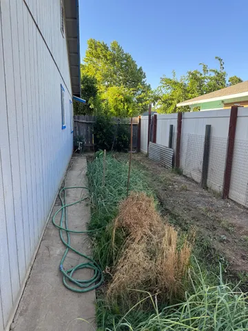 a view of a backyard with sitting area and garden