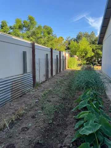 a view of a house with a yard and potted plants