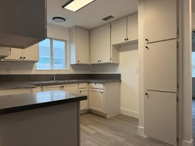 a kitchen with a sink and cabinets