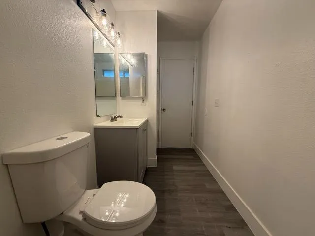 a bathroom with a sink toilet and mirror