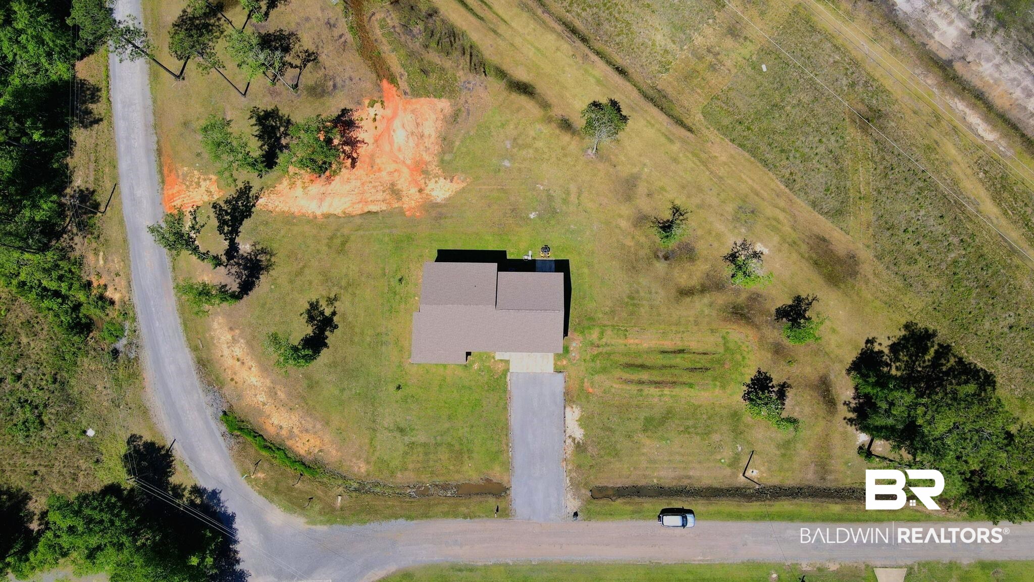 11025 Creax Road Axis, AL 36505 - Photo 38 of 45 Single-story residence on a spacious lot featuring a brown shingle roof, a gravel driveway, and a manicured lawn
