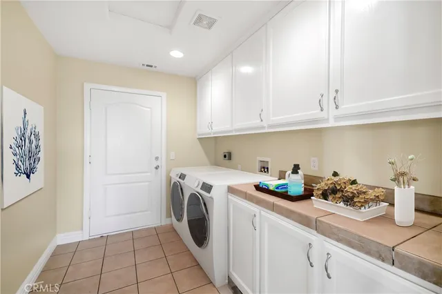 a kitchen with a refrigerator and cabinets