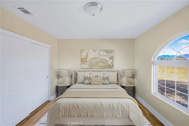 a bedroom with a bed and a window