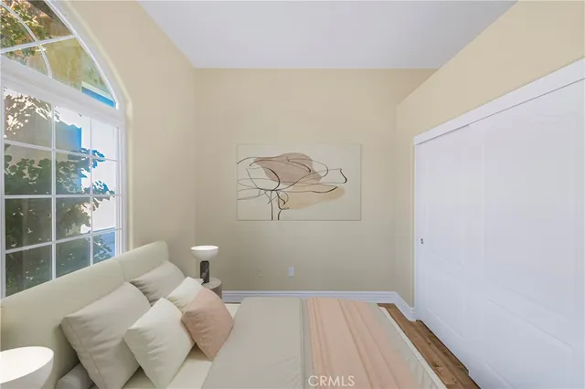 a bedroom with a bed and a window