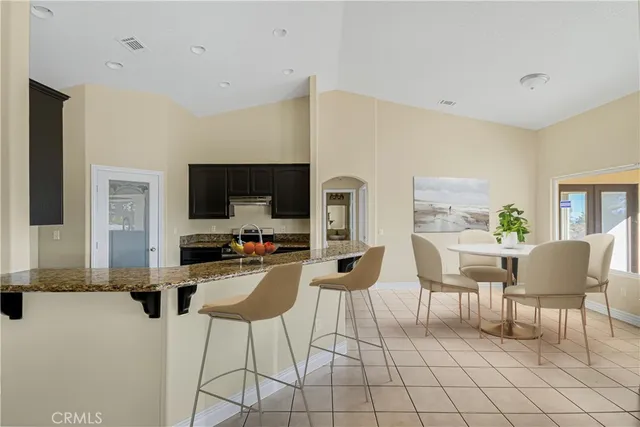 a dining room with furniture and a flat screen tv