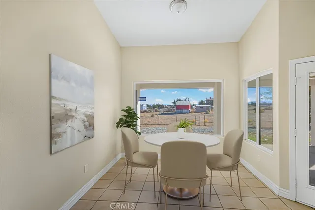 a dining room with furniture and window