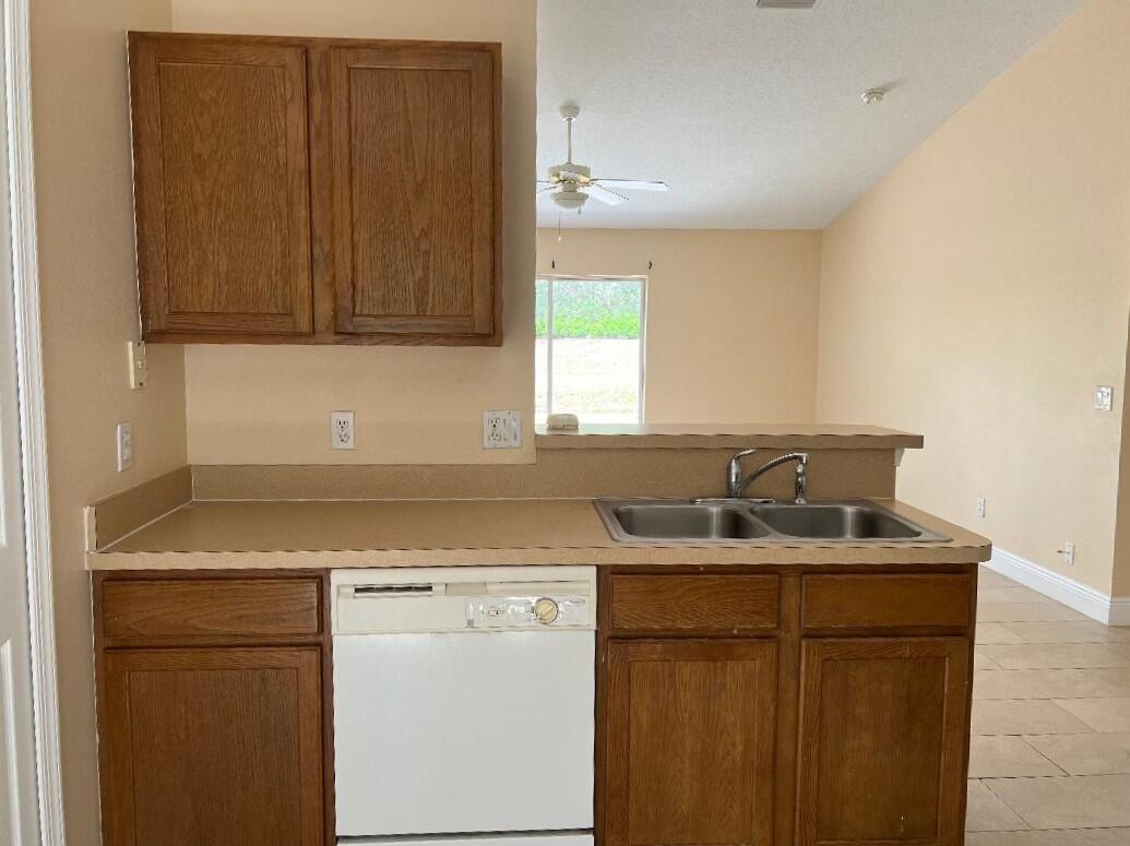 355 Southwest Fairway Avenue Port St. Lucie, FL 34983 - Photo 5 of 8 a kitchen with a sink cabinets and window