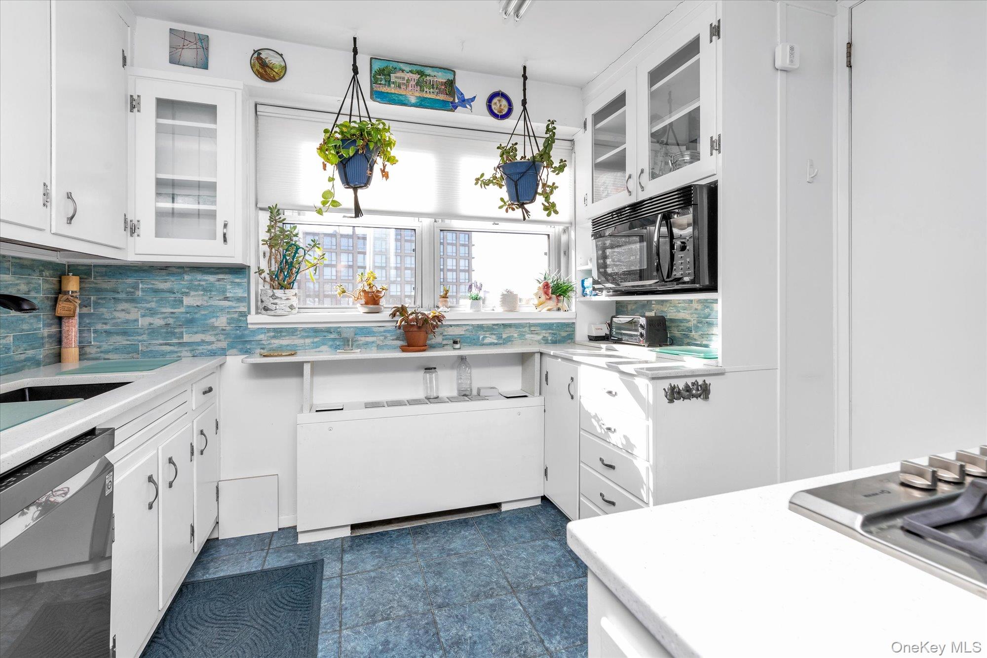 70-20 108th Street, Unit 5P Queens, NY 11375 - Photo 6 of 14 a kitchen with white cabinets and appliances