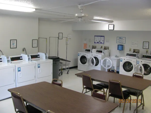 a workspace with kitchen island a stove a table and chairs