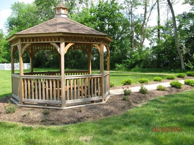 a view of a chair and table in the garden