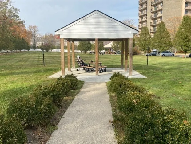 a view of a house with backyard and sitting area