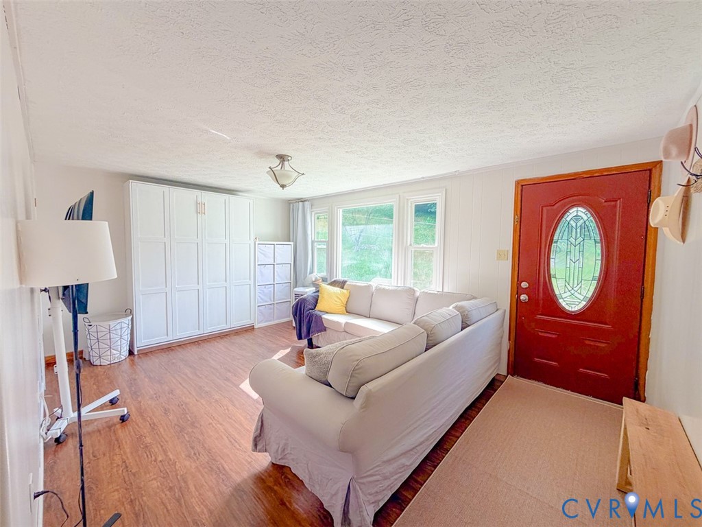 453 Long Hollow Road Cleveland, VA 24225 - Photo 17 of 50 a living room with furniture a window and wooden floor