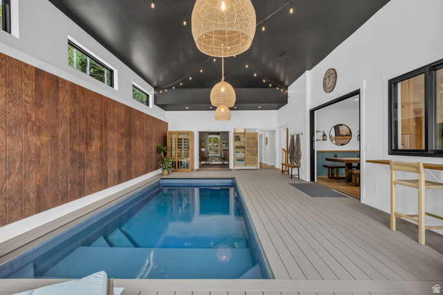 1766 West Tollgate Cyn Road Coalville, UT 84017 - Photo 40 of 59 Indoor swimming pool featuring steps, composite decking, and a wood-finish accent wall