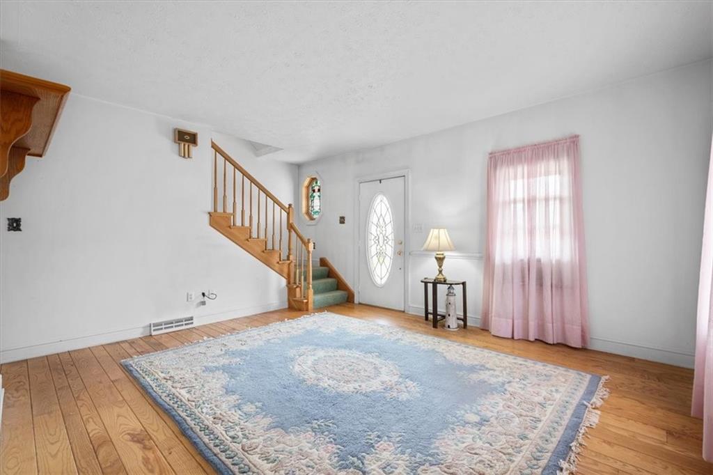 1315 South Main Street Burgettstown, PA 15021 - Photo 17 of 24 a view of a livingroom with wooden floor and a staircase