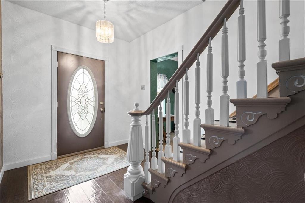 1315 South Main Street Burgettstown, PA 15021 - Photo 2 of 24 a view of staircase with wooden floor and a chandelier