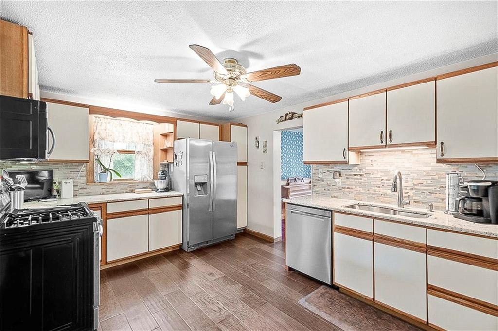 1315 South Main Street Burgettstown, PA 15021 - Photo 3 of 24 a kitchen with stainless steel appliances granite countertop a stove a sink dishwasher and a refrigerator