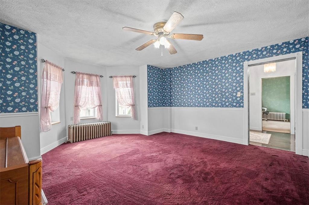 1315 South Main Street Burgettstown, PA 15021 - Photo 5 of 24 an empty room with windows and fan